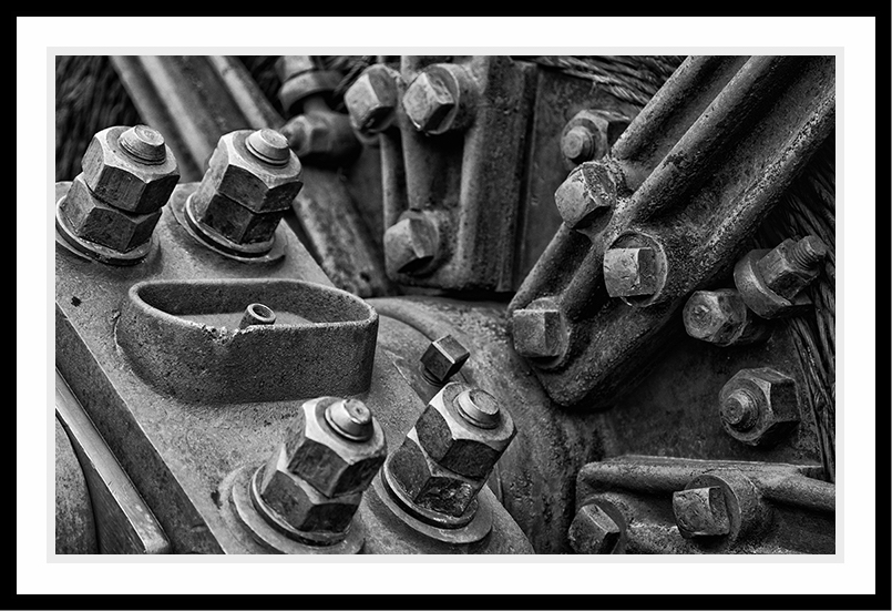 Lots of nuts and bolts on a metal structure.